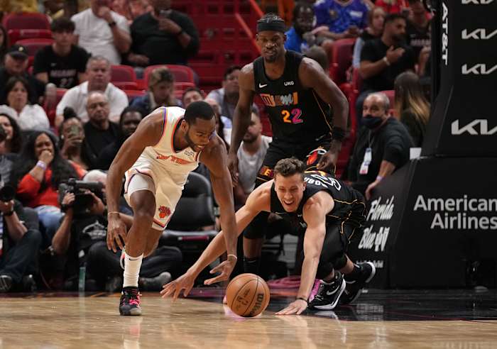 Mar 25, 2022; Miami, Florida, USA; New York Knicks guard Alec Burks (18) and Miami Heat guard Duncan Robinson (55) chase a loose ball during the first half at FTX Arena. Mandatory Credit: Jasen Vinlove-USA TODAY Sports